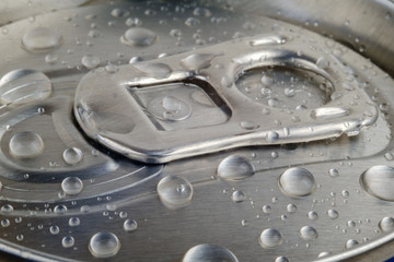 Top of shiny drink can with water drops