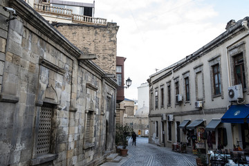 Fototapeta na wymiar Empty street in old city of Baku, Azerbaijan. Old city Baku. Inner City buildings.