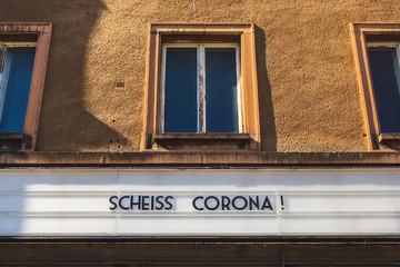 protest about corona virus in letters on advertising panel in german language