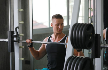 Fototapeta premium man lifting weights in gym