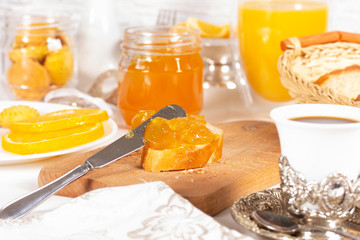 Orange jam with white bread on the table