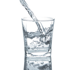 Pouring clean drinking water on a transparent glass. For health concepts. Isolated white background
