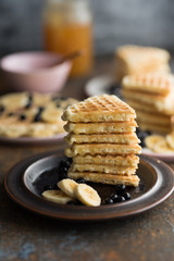 Sweet waffles with banana, blackberries and maple sirup.