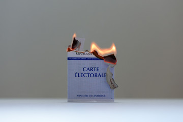 PARIS, FRANCE - MARCH 15, 2020: burning official french electoral voter card symbolizing protest...