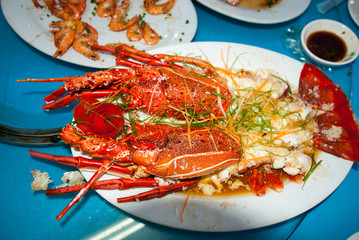 Cooked lobster with spices and herbs on a plate