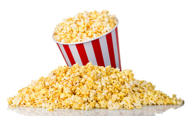 Paper striped bucket on a heap of popcorn isolated on white background