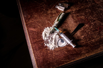A crazed drug addict reaches for another dose of the drug in the syringe. Guy addicted, The concept of anti drugs. male drug addict, drug syringe.
