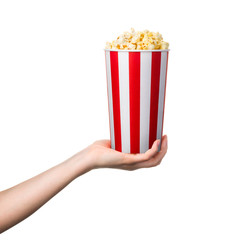 Woman hand holding striped bucket with popcorn isolated on white background