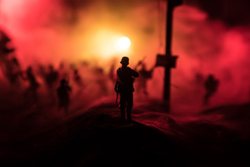 War Concept. Military silhouettes fighting scene on war fog sky background, World War Soldiers Silhouette Below Cloudy Skyline At night. © zef art