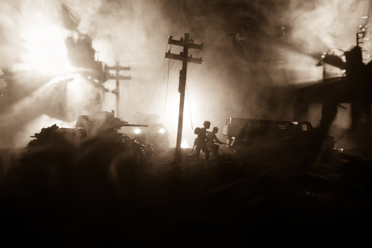 War Concept. Military silhouettes fighting scene on war fog sky background, World War Soldiers Silhouette Below Cloudy Skyline At night.