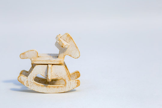 Macro photography of an assembled wooden rocking horse miniature toy.