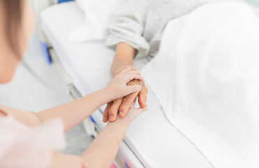 hand in hand, children holding hand of  old patient in hospital, dry and wrinkle skin, elderly health care