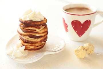 Homemade pancakes with breackfast coffee cup. Healthy morning breakfast with candies.