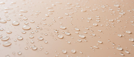Fototapety  Many different drops of water rain on a beige background