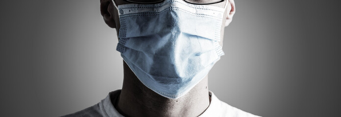 Doctor wearing protection face mask against coronavirus. Banner panorama medical staff preventive...