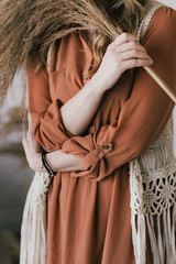 Closeup view vertical photography of beautiful young elegant white woman wearing casual brown dress and knitted vest. © Andrii Oleksiienko