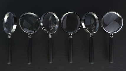 3d render of a line chrome magnifying glass on a black background with depth of field