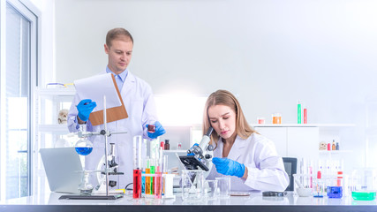 Fototapeta premium Two scientists researching for some confidential in chemical laboratory