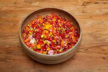 Tomato and Pomegranate Salad in Wooden Bowl