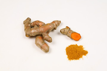 Turmeric powder and fresh turmeric roots isolated on a white background are ingredients in turmeric foods and ingredients in skin care products. Turmeric helps the skin to be strong.