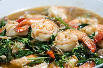 Stir fried shrimp with basil on a white plate. Thai food.