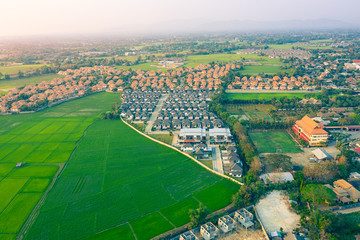 Fototapeta na wymiar Land, landscape of green field in aerial view. Include agriculture farm, house building, village. That real estate or property. Plot of land to housing subdivision, development, sale or investment.