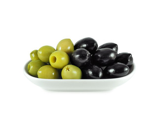 Large dried black olives with stones in oil and pickled green pitted olives in bowl isolated on white background	
