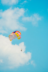 Fototapeta na wymiar man parachuting above the sea