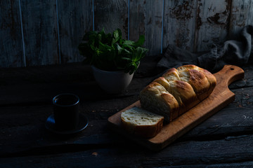 brioche bread on a wooden board, rustic backdrop, old wooden background