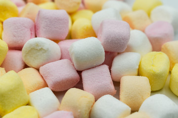 .Colorful mini marshmallows isolated on white background, macro. Fluffy marshmallows texture and pattern