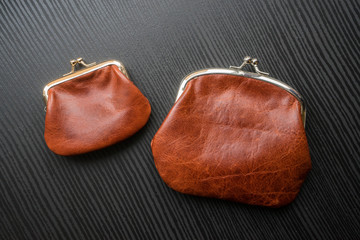 Two brown radicals small and large. Handmade leather wallets of different sizes