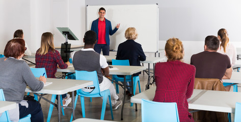 Male teacher giving presentation for students