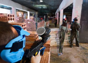 Paintball players aiming in opponents