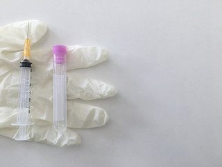 syringe and laboratory check up blood tube collection on glove in medical anual check up concept with copy space