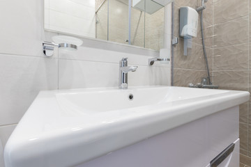 Fragment of a luxury bathroom. Clean, white sink close-up