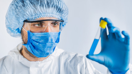 Biology and science. Scientist with test tube with virus or vaccine in it