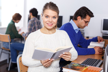 Fototapeta premium Female student working in library