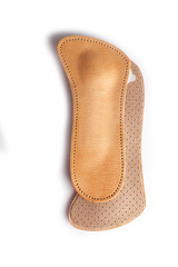 Isolated orthopedic insole on a white background. Treatment and prevention of flat feet and foot diseases. Foot care, comfort for the feet. Wear comfortable shoes. Medical insoles.