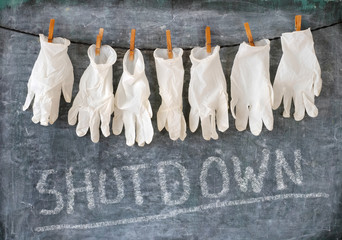 health care system shutdown symbol picture,medical gloves and black board, covid-19, corona virus