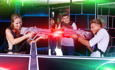 Two emotional players standing opposite each other with laser pi