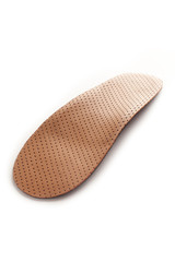 Isolated orthopedic insole on a white background. Treatment and prevention of flat feet and foot diseases. Foot care, comfort for the feet. Wear comfortable shoes. Medical insoles.