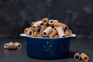 Tri-color pasta in a ceramic pot