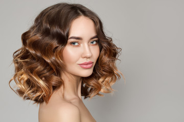 Portrait of a woman with curly hair. Haircut. Shine and hair care