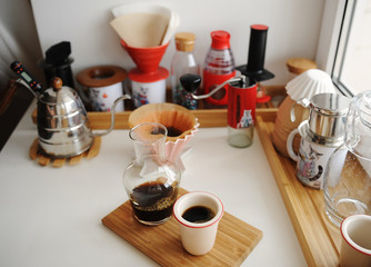 Alternative manual brewing bar. Fresh brewed black pour over coffee. Glass decanter, coffee devices on the background