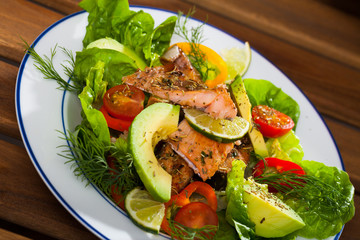 Appetizing fish salad with roasted trout