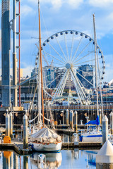 Seattle waterfront and marina with the Ferris wheel on a bright sunny day with clouds