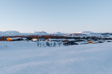 A winter wonderland in Iceland. Photograph shows one of the frozen Icelandic villages during the golden hour. Tourism in Iceland. Visit Iceland any time of the year