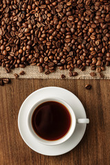 Flat lay composition with a cup of hot coffee and coffee beans