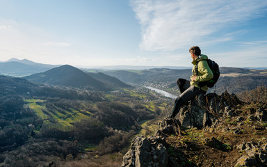 Young sport man backpacker at sunrise seaside mountain peak. Enjoying the beautiful sunset over a...