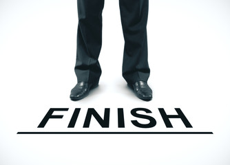 Businessman standing on a finish line